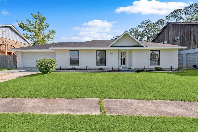 ranch-style home featuring a garage and a front lawn