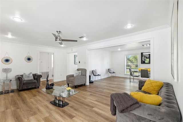 living room featuring light hardwood / wood-style flooring, ornamental molding, and ceiling fan