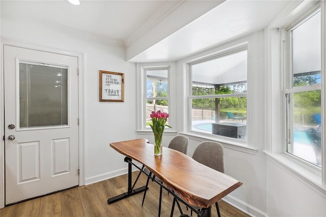 office area featuring light hardwood / wood-style flooring, crown molding, and a wealth of natural light