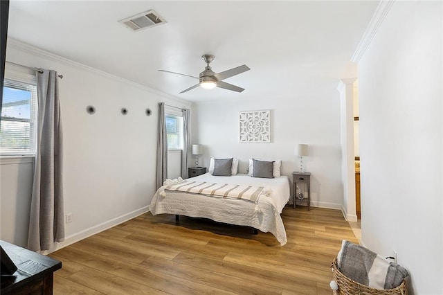 bedroom with ceiling fan, ornamental molding, and light hardwood / wood-style flooring