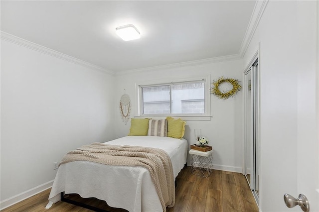 bedroom with ornamental molding, hardwood / wood-style floors, and a closet