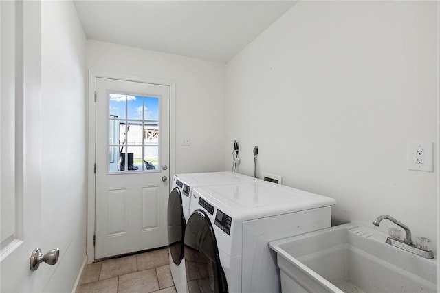 laundry area with separate washer and dryer, sink, and light tile patterned floors