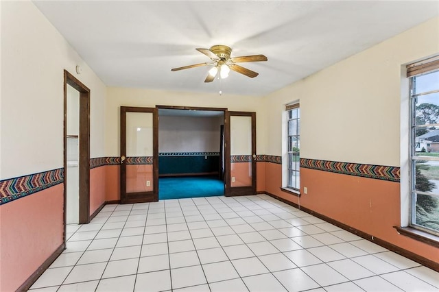 spare room with light tile patterned flooring and ceiling fan