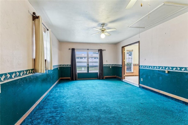 carpeted empty room featuring ceiling fan