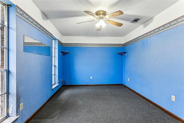 carpeted spare room with ceiling fan