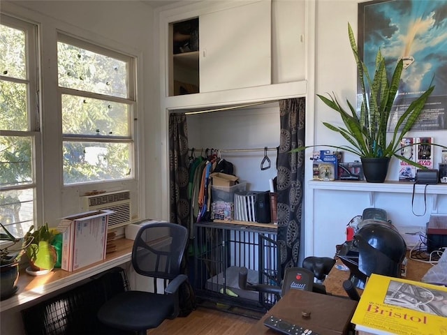 office space with hardwood / wood-style flooring, a healthy amount of sunlight, and cooling unit