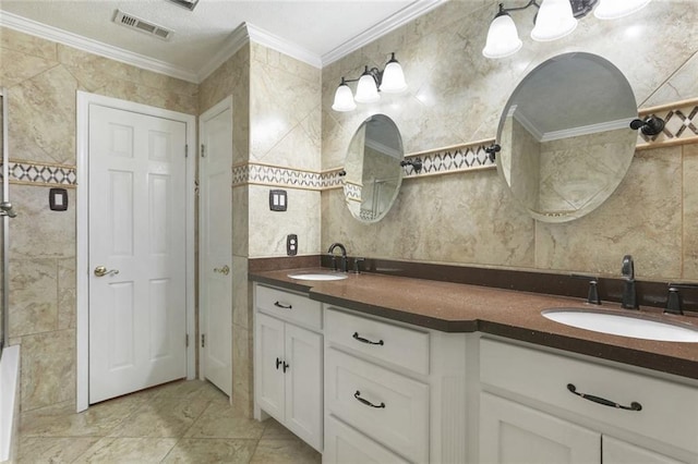 bathroom featuring crown molding, tile patterned floors, vanity, and tile walls