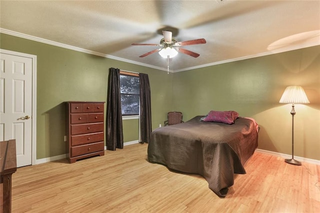 bedroom featuring ornamental molding, ceiling fan, and light hardwood / wood-style floors