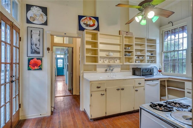 kitchen featuring stove, white dishwasher, a wealth of natural light, and light wood-type flooring