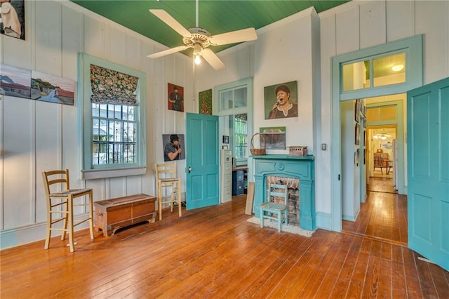 interior space featuring ceiling fan, ornamental molding, and wood-type flooring