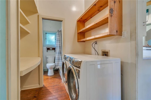 clothes washing area featuring hardwood / wood-style flooring and washer and dryer