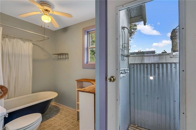 bathroom featuring ceiling fan, independent shower and bath, and toilet