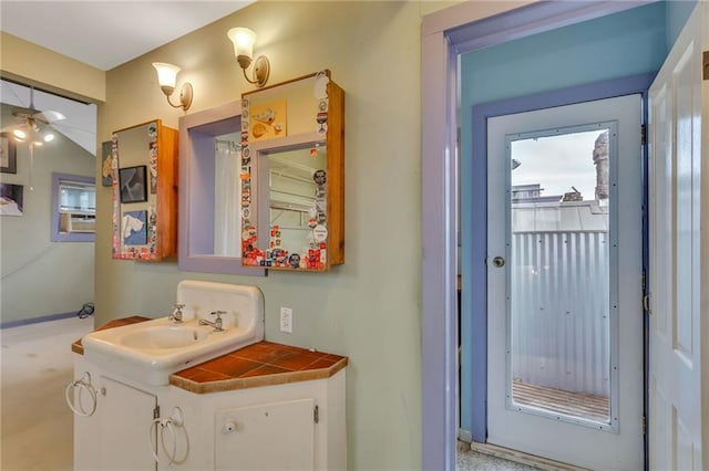 bathroom featuring ceiling fan and vanity