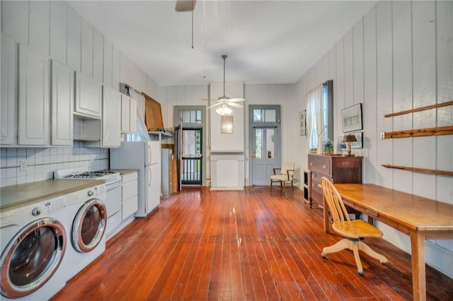 laundry room with ceiling fan, washer and dryer, and light hardwood / wood-style flooring