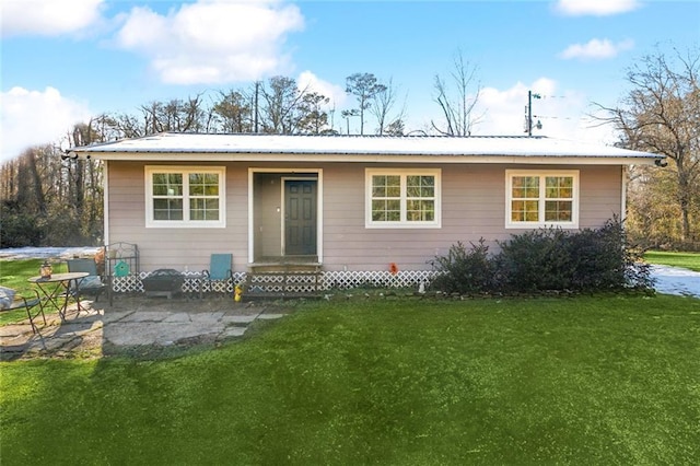 back of property with a patio and a lawn