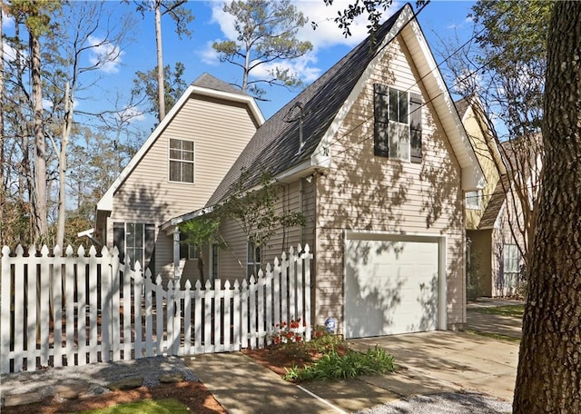 626 S Village Ln Unit A, Mandeville, LA 70471 - view of front facade featuring a garage, concrete driveway, and roof with shingles
