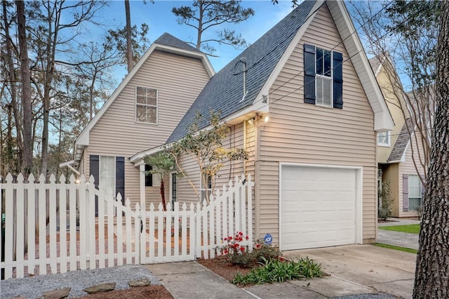626 S Village Ln Unit A, Mandeville, LA 70471 - view of front of home with an attached garage, roof with shingles, and driveway