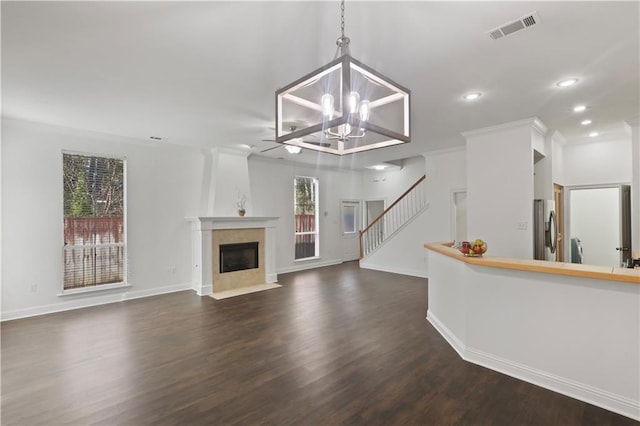 626 S Village Ln Unit A, Mandeville, LA 70471 - unfurnished living room with a chandelier, dark wood-type flooring, a fireplace with flush hearth, recessed lighting, and baseboards