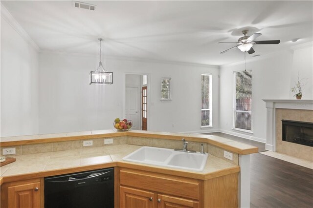 626 S Village Ln Unit A, Mandeville, LA 70471 - kitchen featuring dishwasher, a sink, open floor plan, crown molding, and wood finished floors
