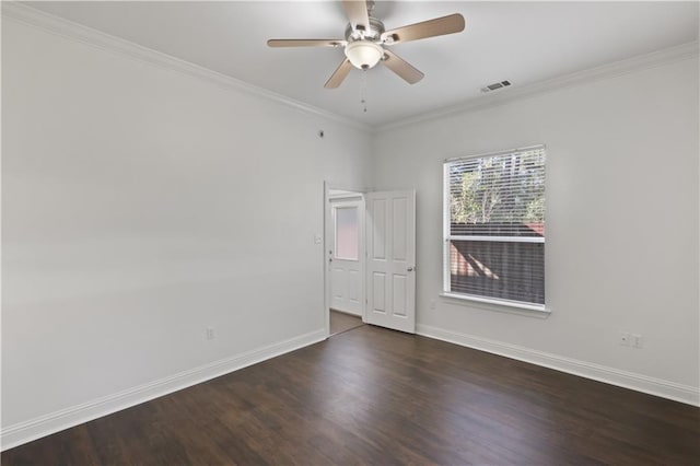 empty room featuring dark wood-type flooring, ornamental molding, and ceiling fan