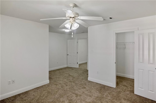 unfurnished bedroom featuring light carpet, a closet, and ceiling fan