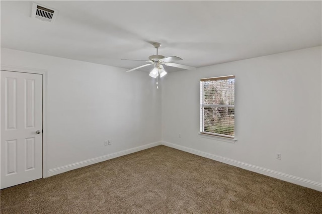 carpeted spare room with ceiling fan