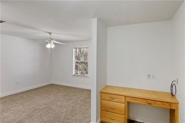 unfurnished office featuring light colored carpet and ceiling fan