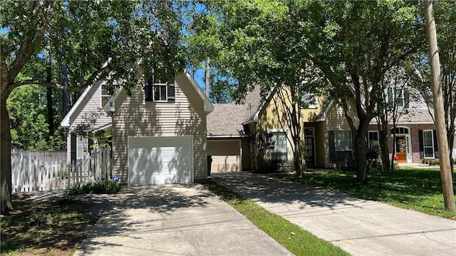 626 S Village Ln Unit A, Mandeville, LA 70471 - view of front facade with concrete driveway, an attached garage, and brick siding