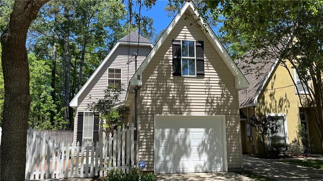 626 S Village Ln Unit A, Mandeville, LA 70471 - view of front of home with driveway and an attached garage