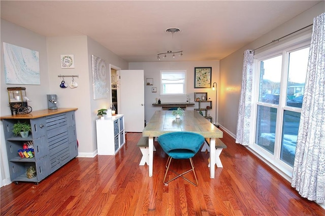 dining room with wood-type flooring and plenty of natural light