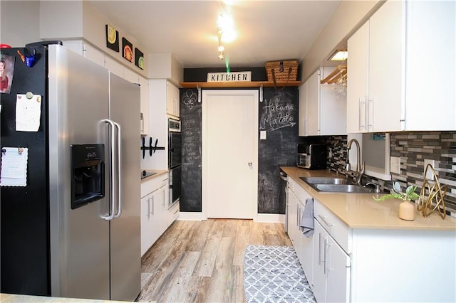 kitchen featuring white cabinetry, sink, tasteful backsplash, and appliances with stainless steel finishes