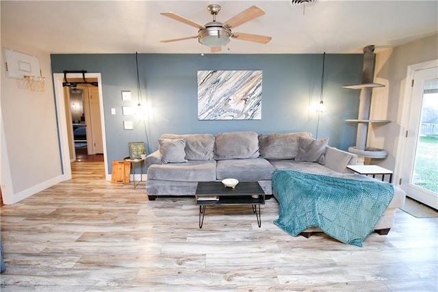 living room featuring ceiling fan and light hardwood / wood-style floors