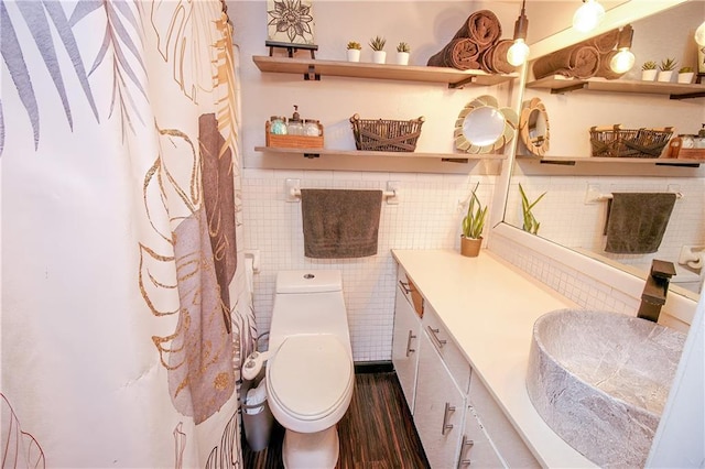 bathroom featuring hardwood / wood-style flooring, vanity, tile walls, and toilet