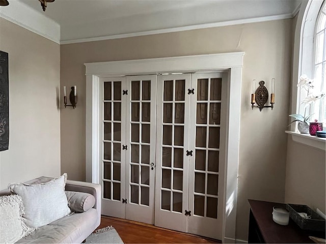 entryway featuring hardwood / wood-style flooring, ornamental molding, and french doors