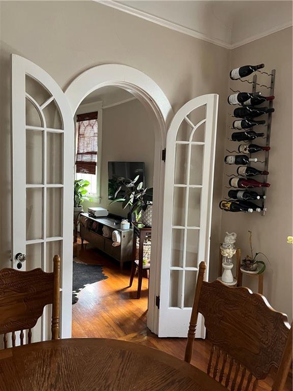 interior space with hardwood / wood-style floors and crown molding