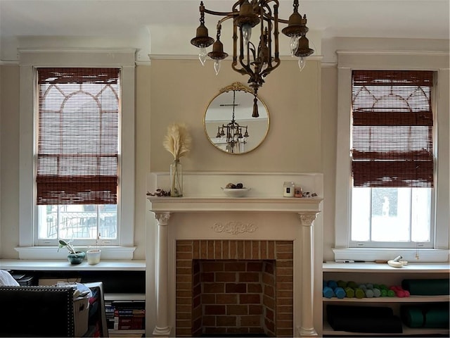 interior space featuring a brick fireplace and a notable chandelier