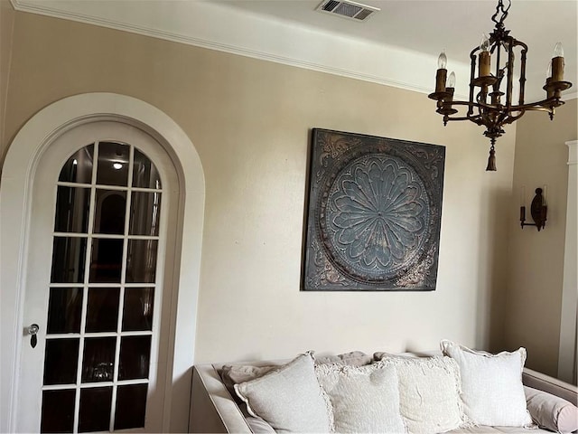 bedroom featuring ornamental molding and an inviting chandelier