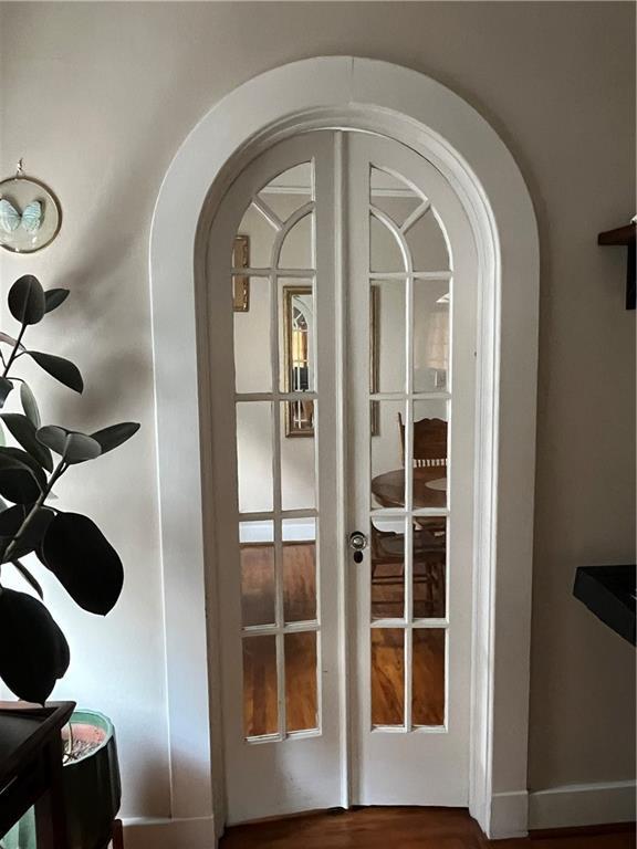 room details with french doors and wood-type flooring