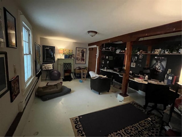 interior space featuring a baseboard heating unit and concrete floors