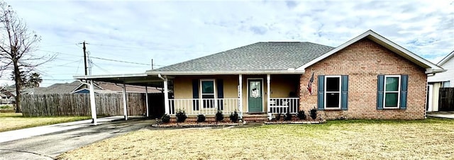 view of front of house featuring a front yard, a carport, and a porch