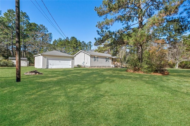 exterior space featuring an outbuilding, a garage, and a front yard