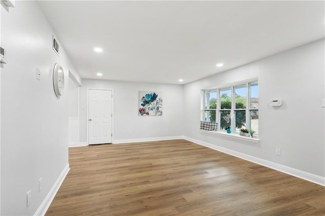 spare room with wood-type flooring