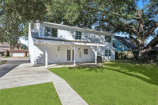 view of front of home featuring french doors and a front lawn