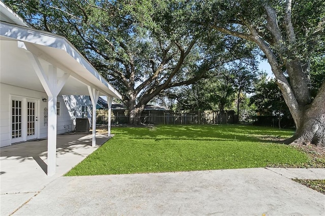 view of yard with a patio, central AC unit, and french doors