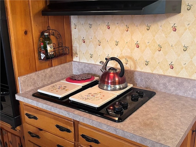 kitchen featuring range hood and black gas cooktop