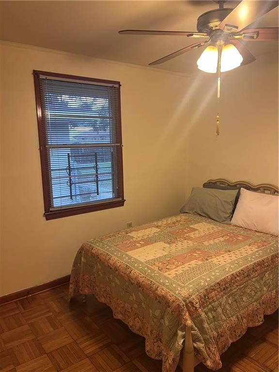 bedroom featuring ceiling fan and parquet flooring