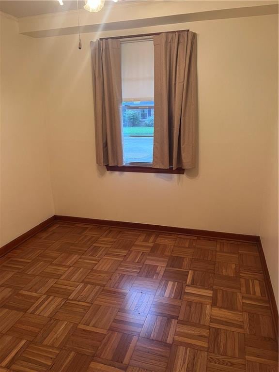 unfurnished room with dark parquet flooring