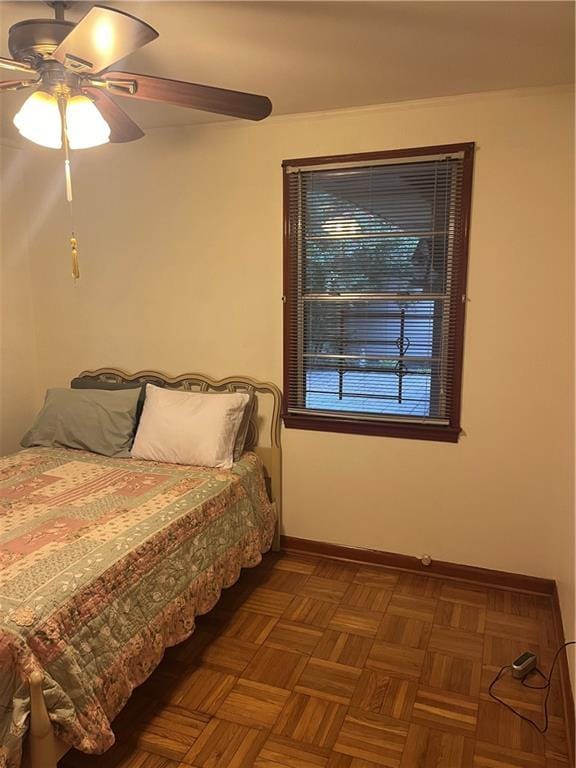 bedroom featuring dark parquet floors and ceiling fan