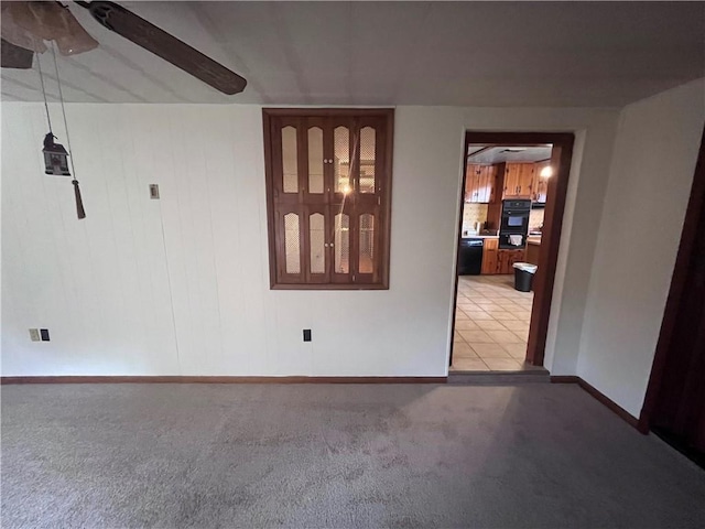 spare room featuring ceiling fan and carpet floors