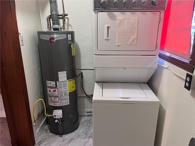 laundry room featuring water heater and stacked washer / dryer